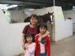 Maria & daughters at the stable